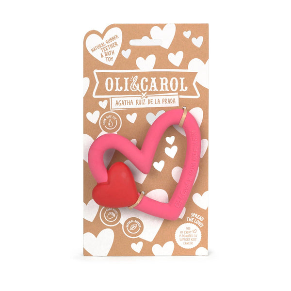 Heart-shaped pink and red toy with Oli & Carol branding on a brown background