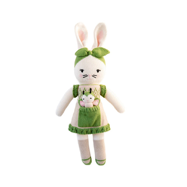 White stuffed bunny rabbit toy wearing a green outfit