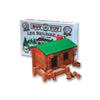Toy log cabin set with green roof and red accents, displayed in front of Roy Toy packaging.
