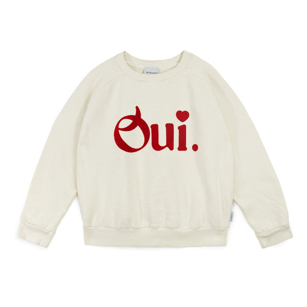 Beige sweatshirt with 'Oui' printed in red