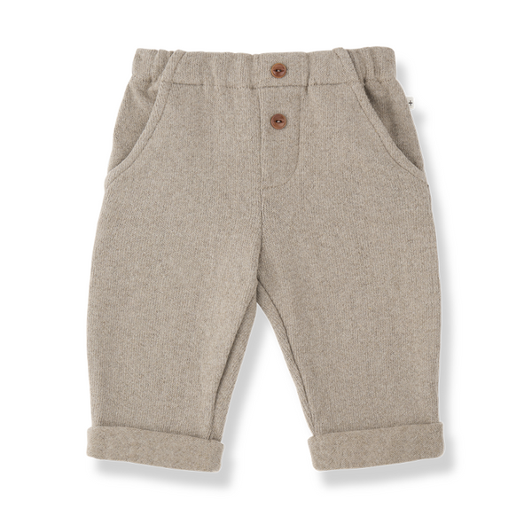A pair of toddler's beige heathered wool trousers with a buttoned front and rolled cuffs,