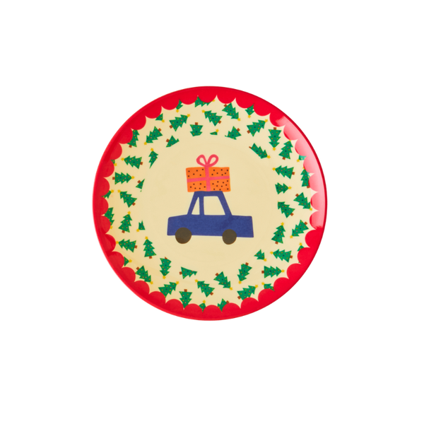 Round plate with a festive design of a blue car carrying a gift, surrounded by green trees on a red border.