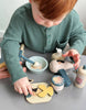 Wooden toy hair salon set with mirror, chairs, and various tools 