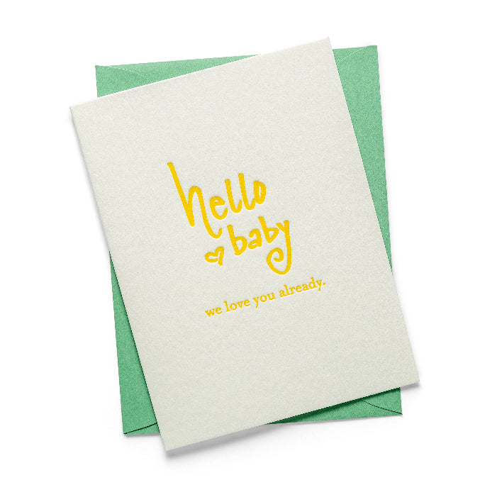 Greeting card with 'hello baby, we love you already' text 
