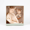 Set of baby toys including a plush toy, a blanket, and a rattle in a decorative box with a patterned interior.