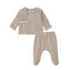 A two-piece baby outfit set in a soft oatmeal beige knit, featuring a long-sleeve wrap-style top with a drawstring detail and matching footed pants