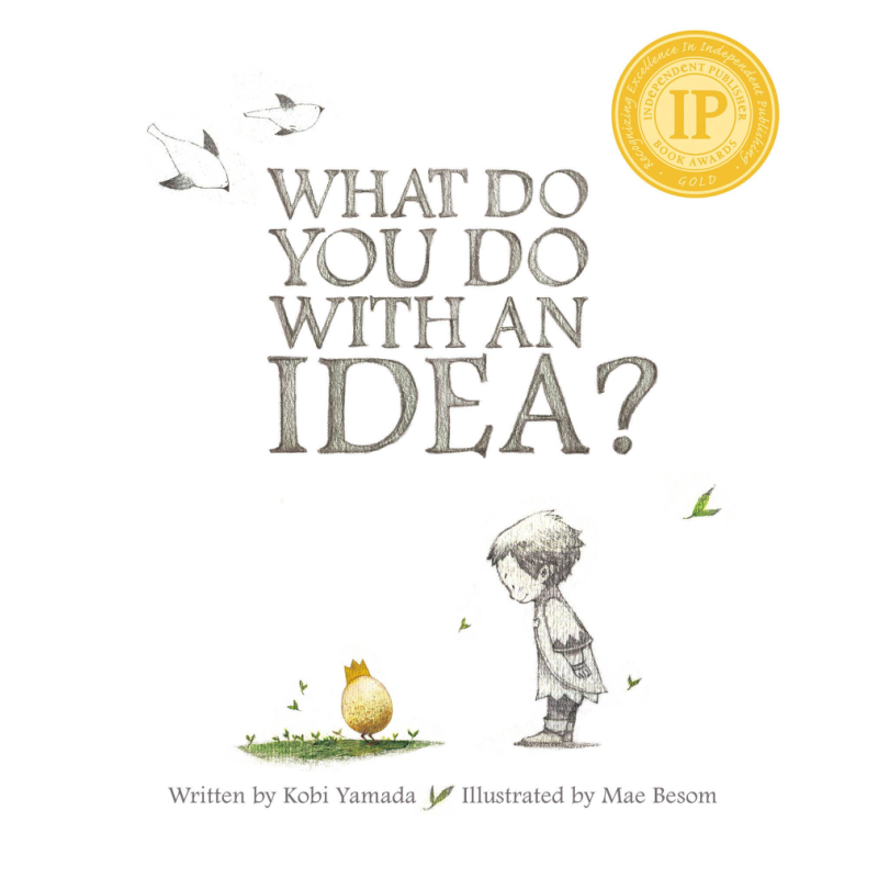 Book cover for 'What Do You Do With an Idea?' featuring a child looking at a small yellow object on grass, with birds and a gold IPPY award seal 