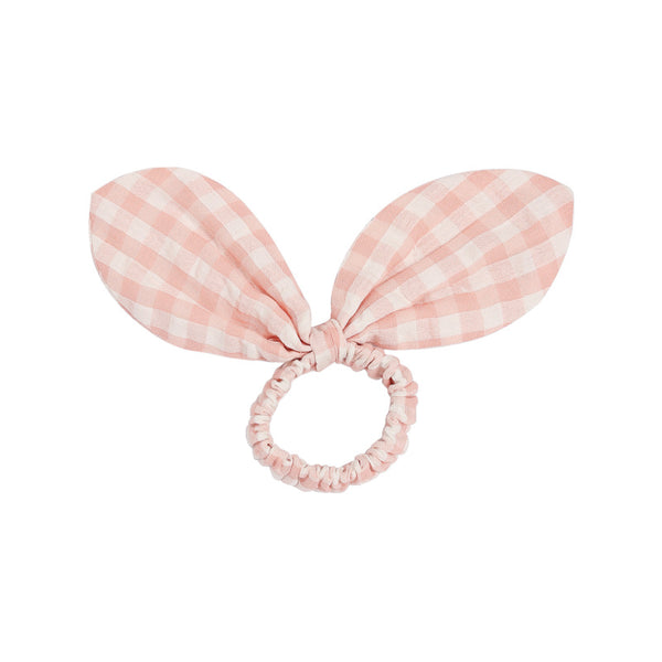 Pink checkered bunny ear hair tie on a white background
