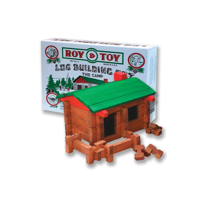 Toy log cabin set with green roof and red accents, displayed in front of Roy Toy packaging.
