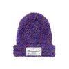 Purple fuzzy beanie with a brand label 