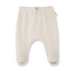 A pair of baby footed pants in a light cream or off-white cotton fabric, featuring an elastic waistband with a small decorative button and a small brand tag on the side.