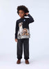 Child wearing a black long-sleeve shirt with a dog graphic