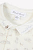 Close-up of a baby outfit with 'Tantine et Chocolat' label and rabbit pattern.