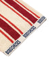 Striped rug with red and beige stripes and 'BOBO CHOSES' branding 