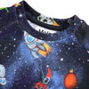 Children's clothing with space-themed design featuring rockets and stars on a dark blue background.