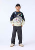 Child wearing a dark sweater with colorful graphics 