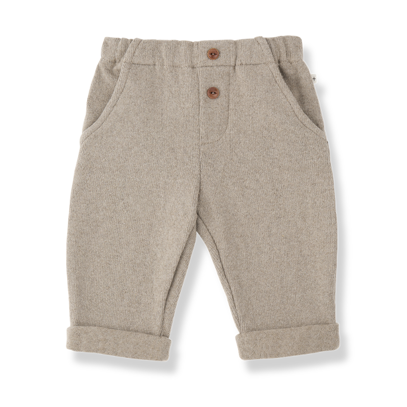 A pair of toddler's beige heathered wool trousers with a buttoned front and rolled cuffs,