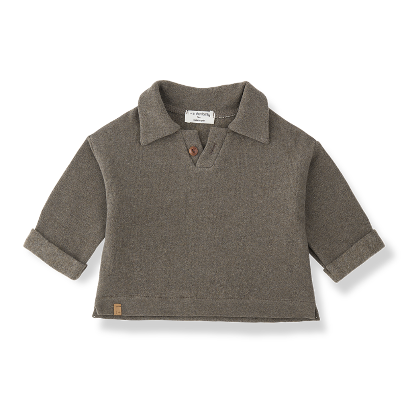 A children's short-sleeve knit polo shirt in a muted taupe-brown color, featuring a collar, a single brown button, and rolled cuffs
