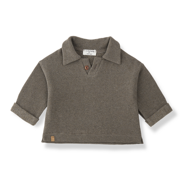 A children's short-sleeve knit polo shirt in a muted taupe-brown color, featuring a collar, a single brown button, and rolled cuffs