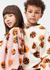 Two children wearing sweatshirts with basketball patterns 