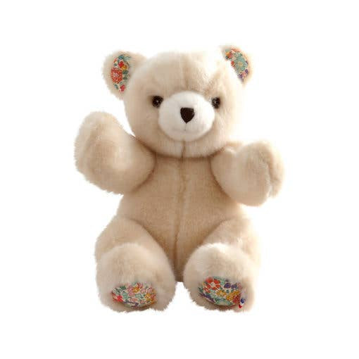 Beige teddy bear with floral patterns on 